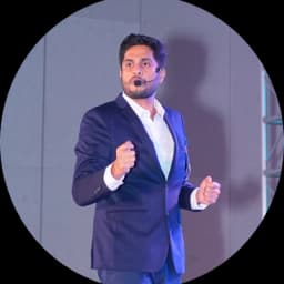 Jishnu Gopi speaking on stage